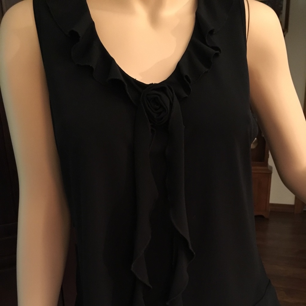 Sleeveless black blouse with ruffle collar